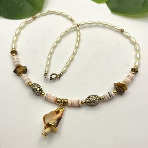 Beautiful vintage necklace, spiral shell, with its edges gilded with gold.